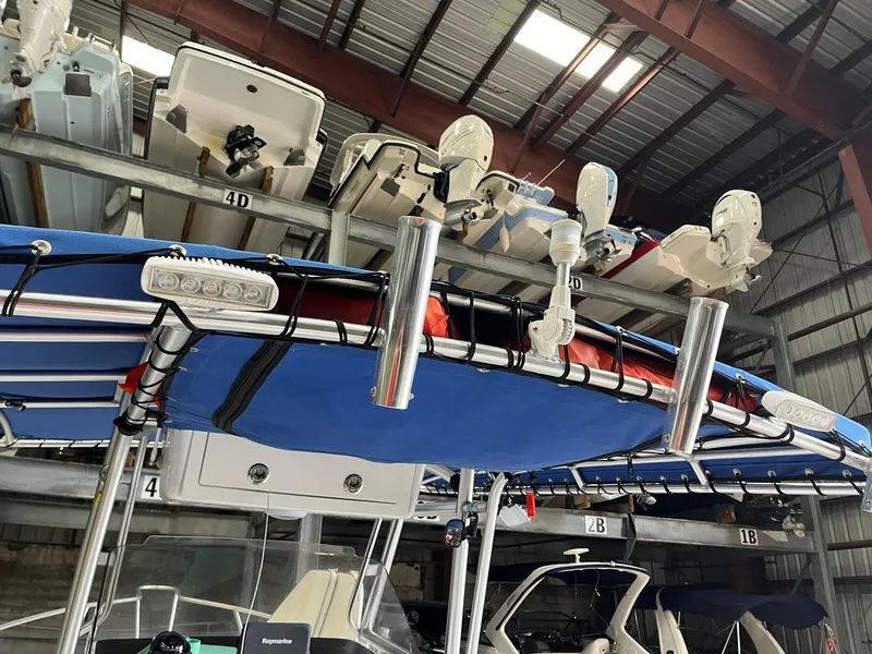 Slide: The Image of 2001 Pro-Line 25 Sport boat stored in a warehouse with other boats. - 13