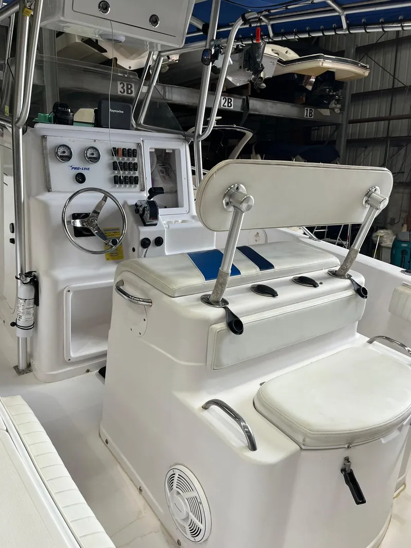 Slide: The Image of 2001 Pro-Line 25 Sport boat interior with helm and seating. - 14