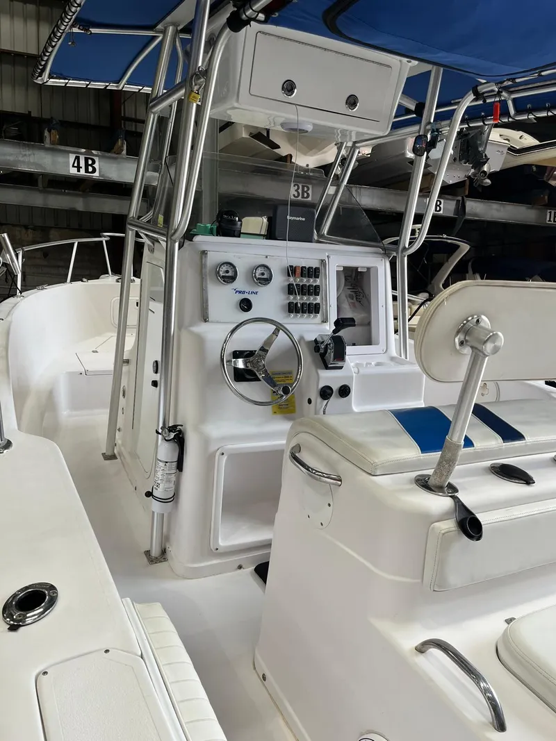 Slide: The Image of 2001 Pro-Line 25 Sport boat interior with steering console and seating. - 15