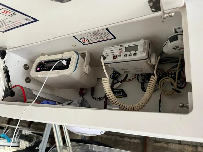 Slide: The Image of 2001 Pro-Line 25 Sport boat electronics compartment with radio and communication devices. - 17