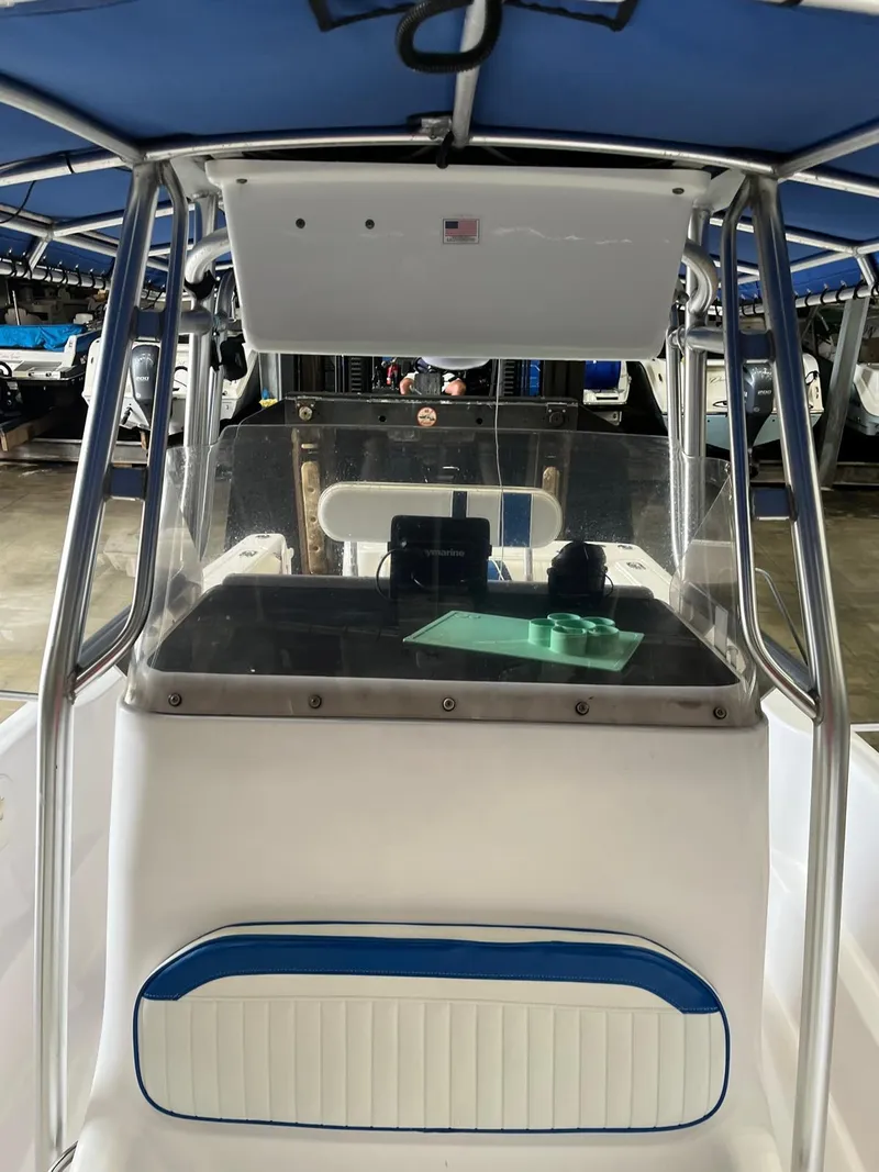 Slide: The Image of 2001 Pro-Line 25 Sport boat interior with console and blue canopy. - 18