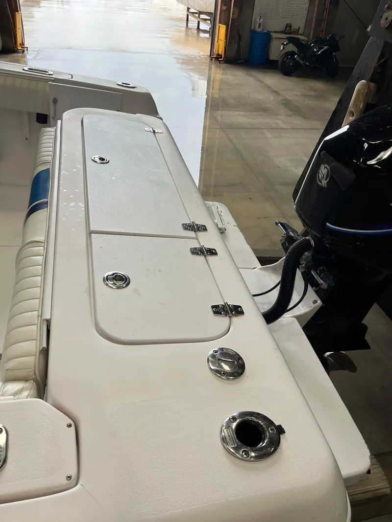 Slide: The Image of 2001 Pro-Line 25 Sport boat interior with motor, in a storage facility. - 22