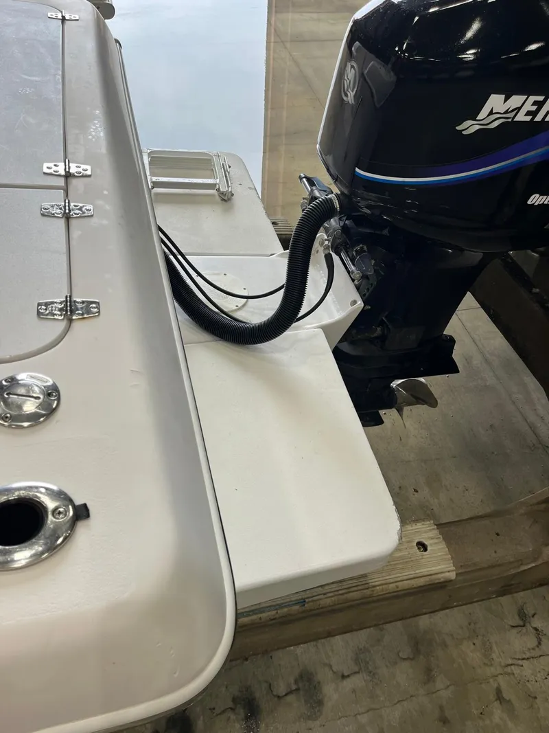Slide: The Image of 2001 Pro-Line 25 Sport boat with Mercury outboard motor in a workshop. - 23
