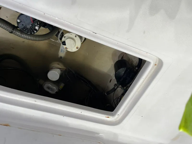 Slide: The Image of Open compartment of 2001 Pro-Line 25 Sport boat showing internal wiring and components. - 24