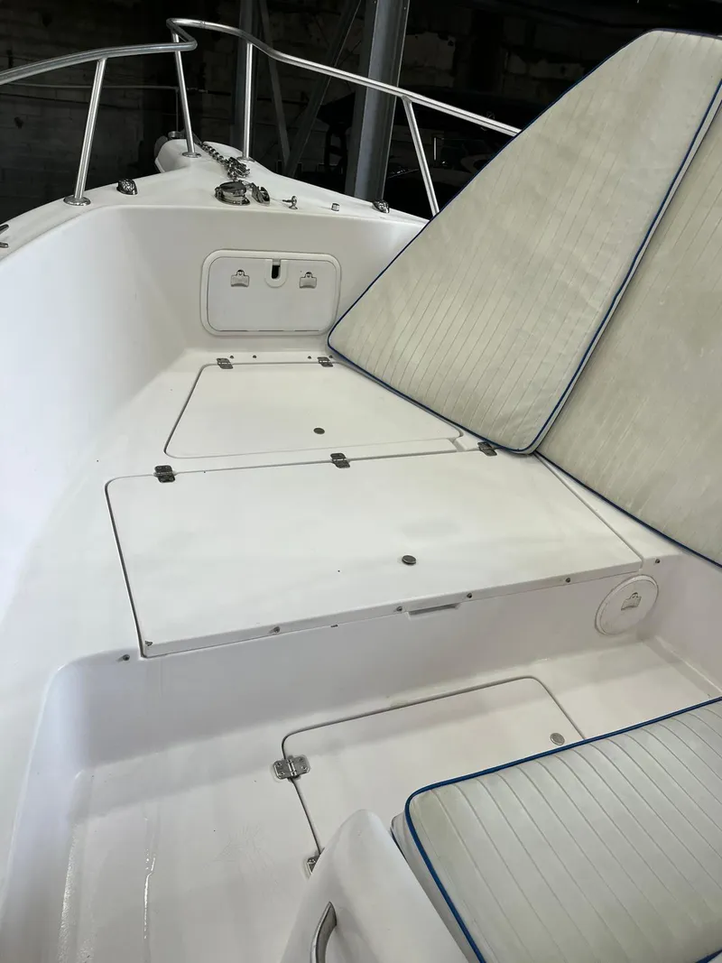 Slide: The Image of 2001 Pro-Line 25 Sport boat interior with cushioned seating and storage compartments. - 25
