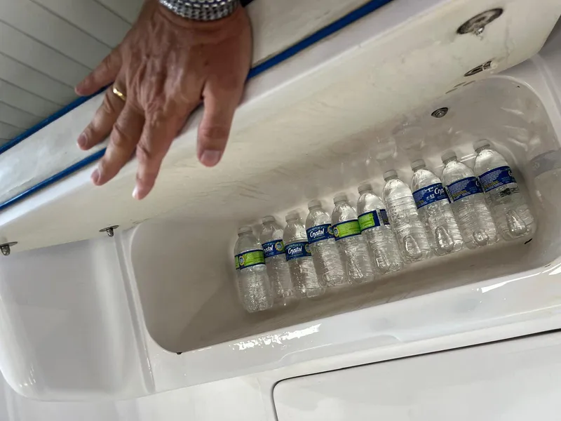 Slide: The Image of Storage compartment with water bottles in a 2001 Pro-Line 25 Sport boat. - 26
