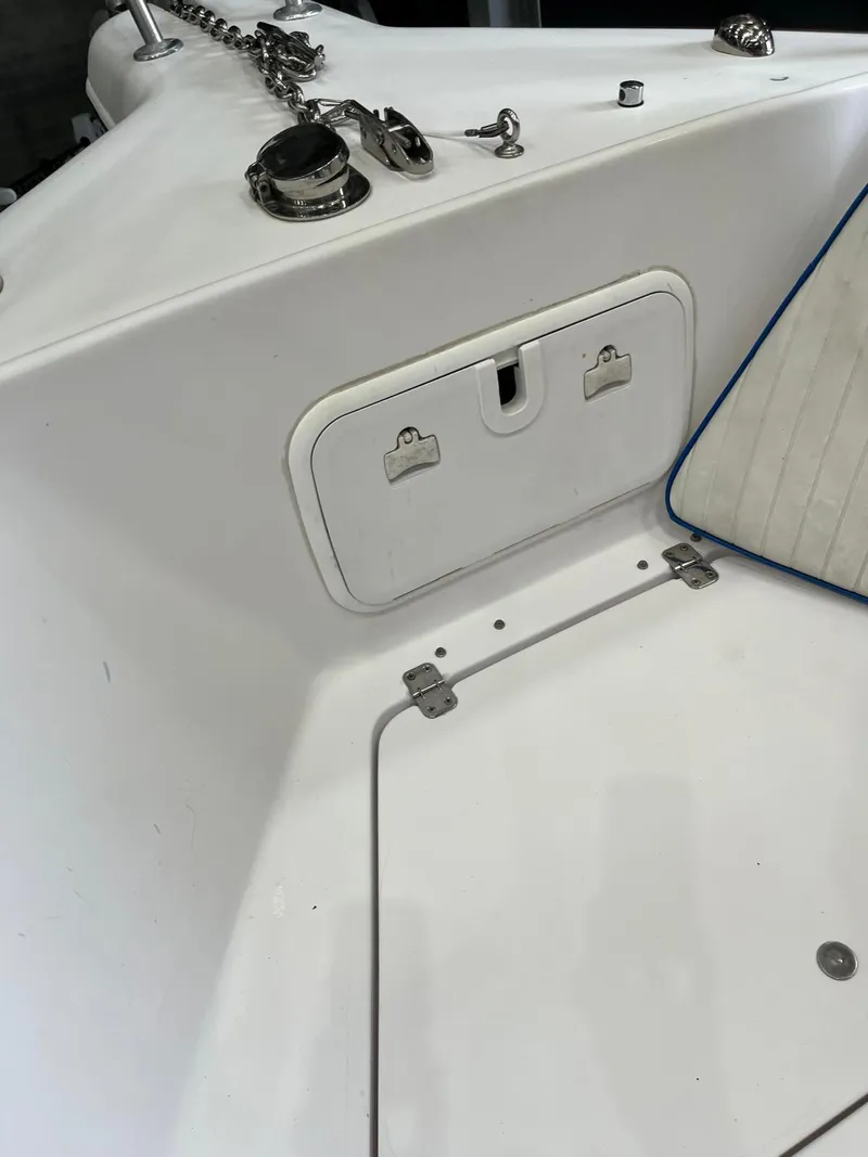 Slide: The Image of 2001 Pro-Line 25 Sport boat deck with storage compartment and anchor chain. - 27