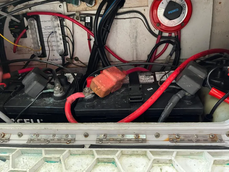 Slide: The Image of 2001 Pro-Line 25 Sport boat battery compartment with wiring and connections. - 28