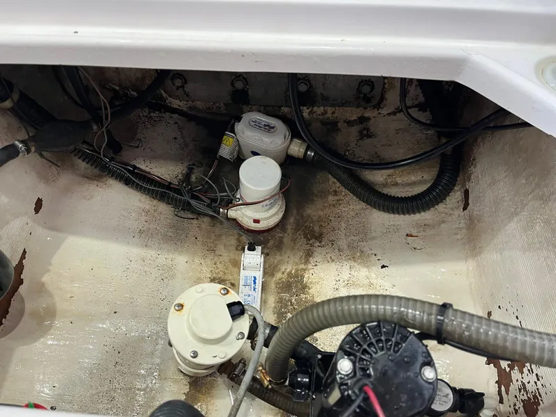 Slide: The Image of 2001 Pro-Line 25 Sport boat bilge area with pumps and wiring. - 29