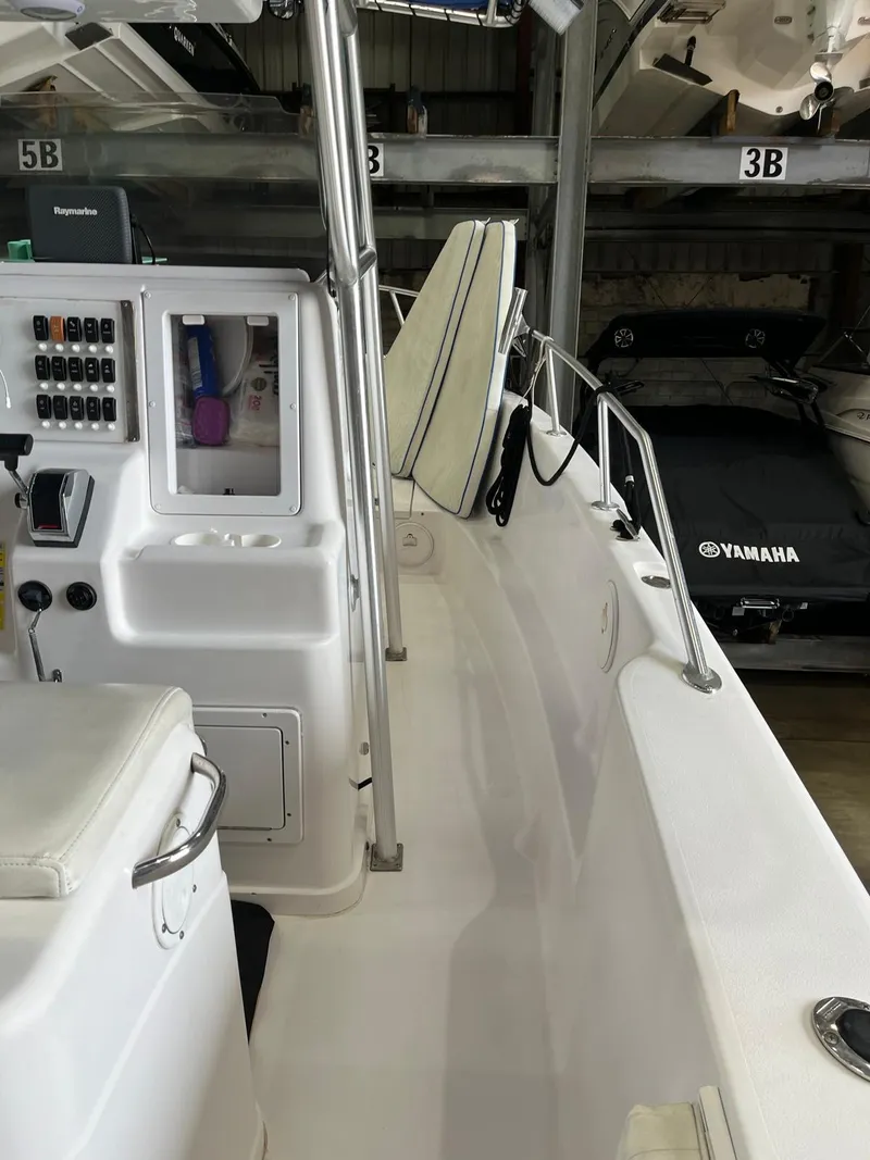 Slide: The Image of 2001 Pro-Line 25 Sport boat interior with control panel and seating. - 30