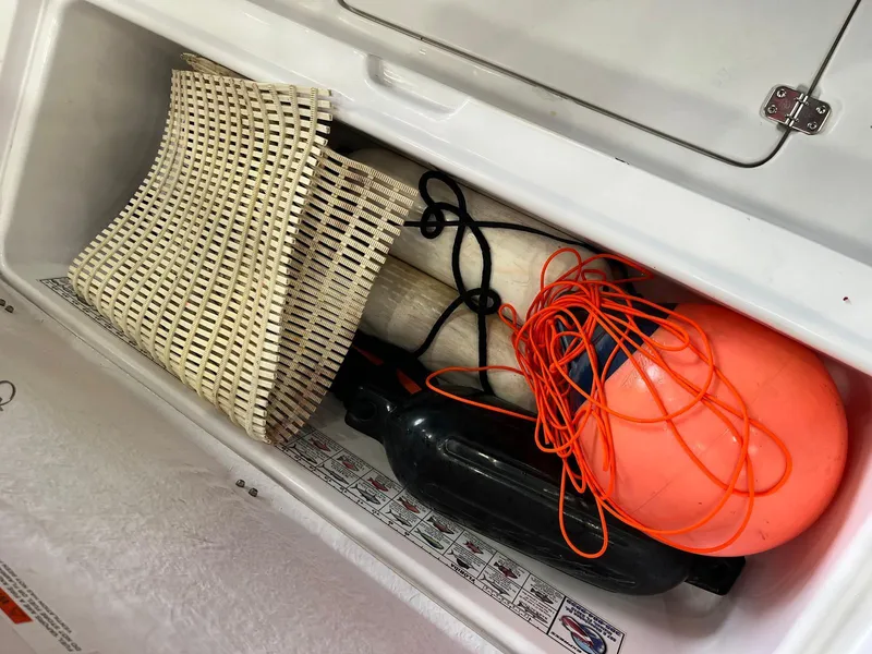 Slide: The Image of Storage compartment in 2001 Pro-Line 25 Sport boat with marine equipment. - 31