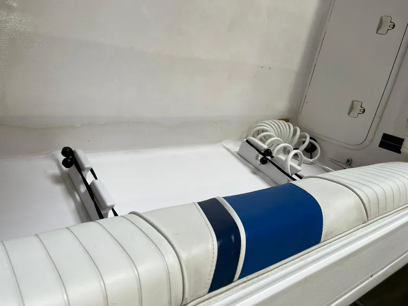 Slide: The Image of 2001 Pro-Line 25 Sport boat interior with white and blue seating. - 32