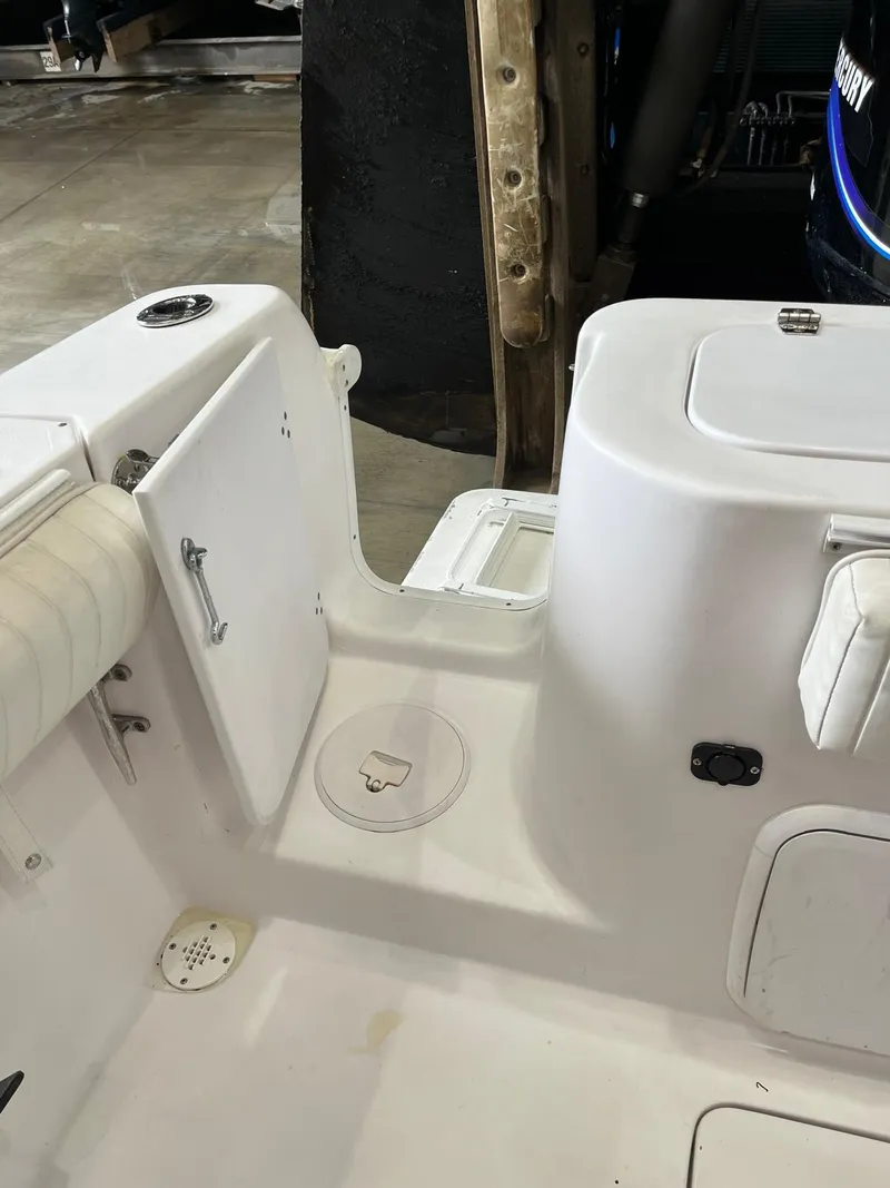 Slide: The Image of 2001 Pro-Line 25 Sport boat interior, featuring storage compartments and seating. - 34