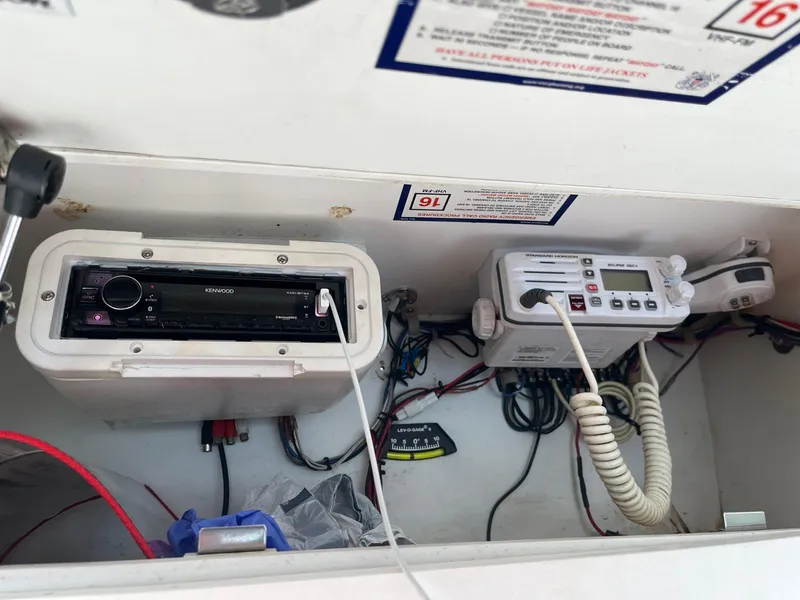 Slide: The Image of 2001 Pro-Line 25 Sport boat electronics, featuring a Kenwood stereo and marine radio system. - 35