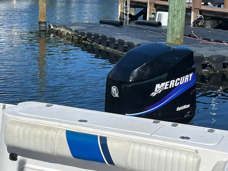 Slide: The Image of 2001 Pro-Line 25 Sport boat with Mercury outboard engine at dock. - 37