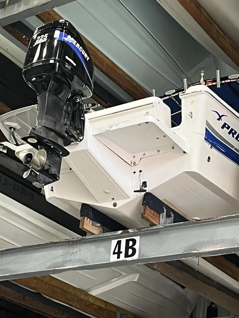 Slide: The Image of 2001 Pro-Line 25 Sport boat with Mercury outboard engine in storage rack. - 5