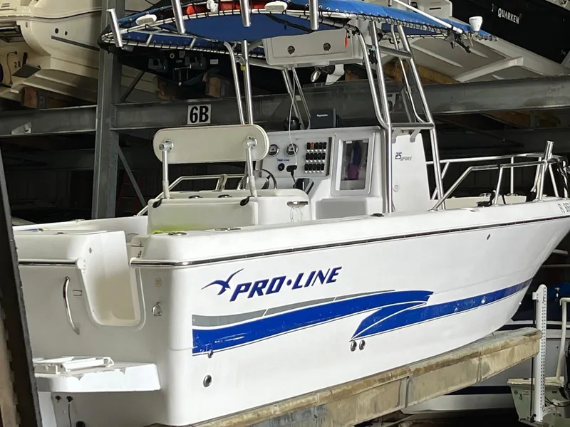 Slide: The Image of 2001 Pro-Line 25 Sport boat with blue accents in storage. - 8