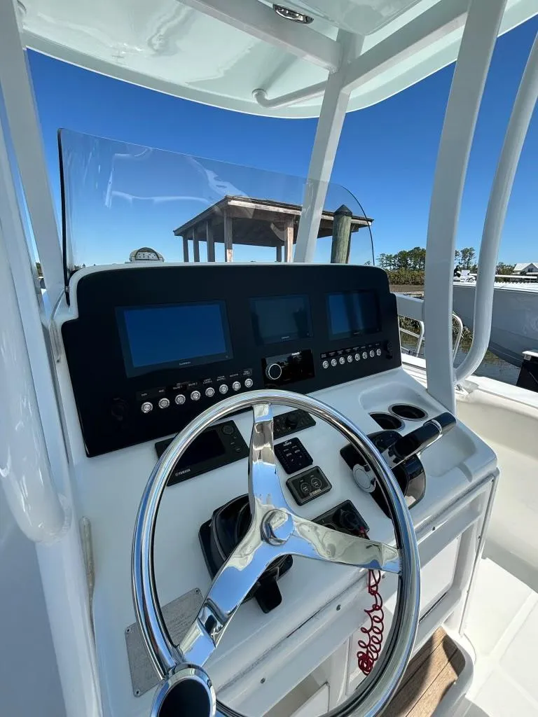 Slide: The Image of 2014 Sea Hunt Gamefish 27 helm with modern controls and dual displays. - 4
