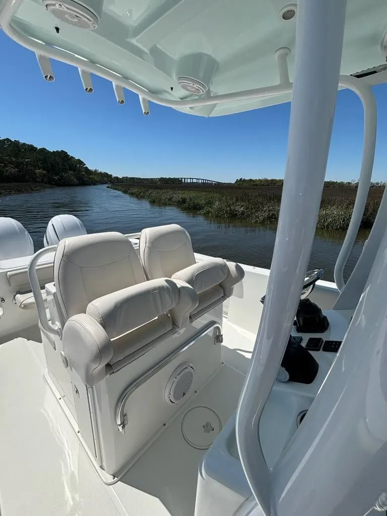Slide: The Image of 2014 Sea Hunt Gamefish 27 boat with forward seating on a calm river. - 5