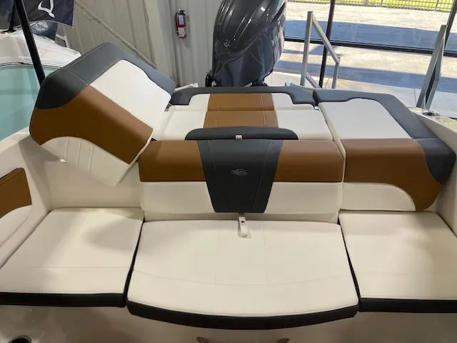 Slide: The Image of 2025 Chaparral 21 SSi OB boat interior with brown and white seating. - 7
