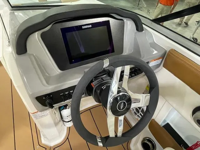 Slide: The Image of 2025 Chaparral 21 SSi OB boat dashboard with steering wheel and digital display. - 9