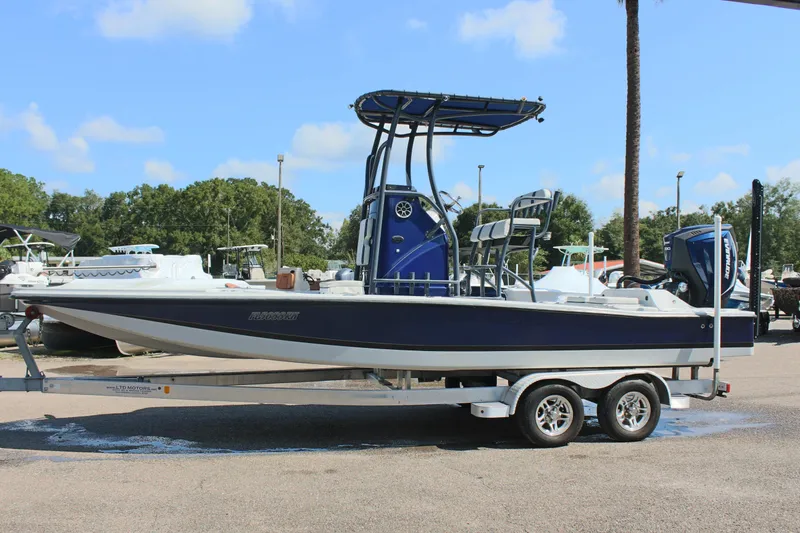 The Image of 2017 Tiburon ZX-25 boat on trailer, parked outdoors under blue sky. - 1