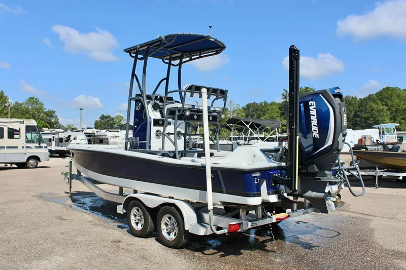 Slide: The Image of 2017 Tiburon ZX-25 boat on trailer with Evinrude engine in parking lot. - 10