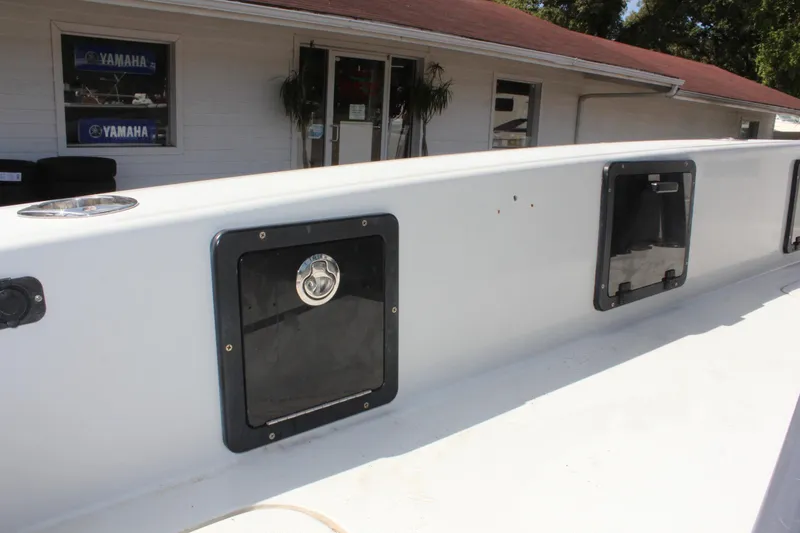 Slide: The Image of 2017 Tiburon ZX-25 boat with storage compartments, parked outside a Yamaha dealership. - 21