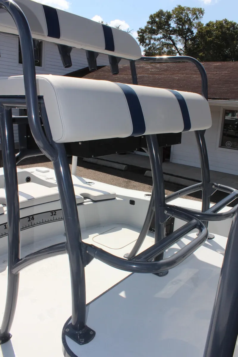 Slide: The Image of 2017 Tiburon ZX-25 boat seating with blue and white cushioned seats. - 25