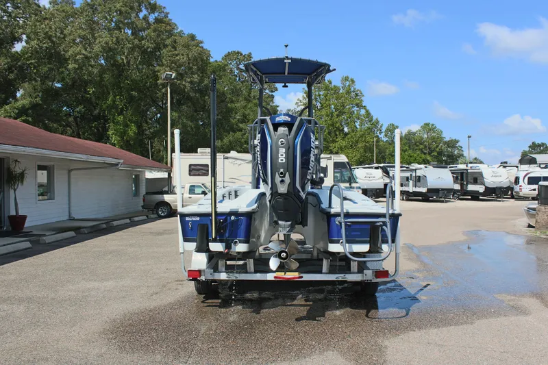 Slide: The Image of 2017 Tiburon ZX-25 boat on trailer, parked outdoors near RVs. - 9