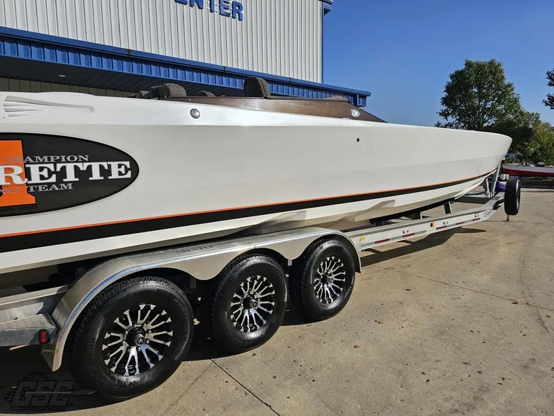 Slide: The Image of 2003 Cigarette 36 Gladiator boat on trailer, parked outdoors. - 10