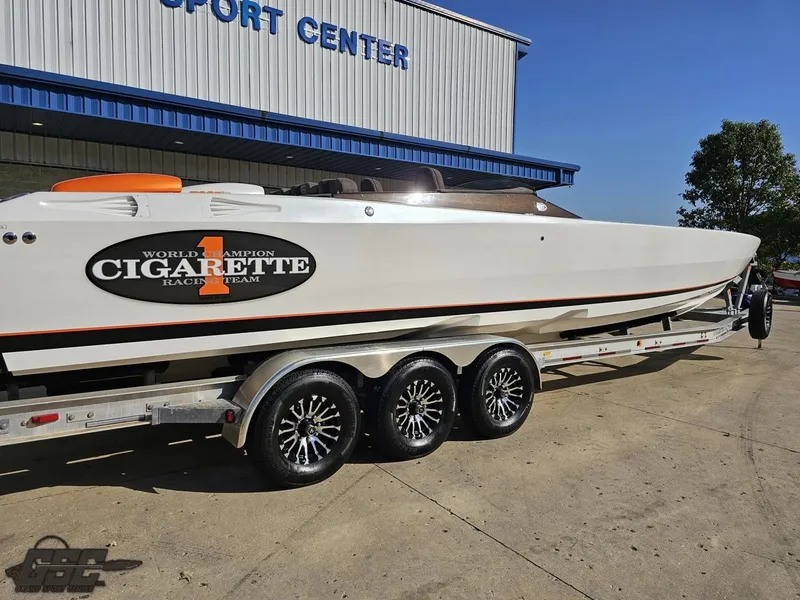 Slide: The Image of 2003 Cigarette 36 Gladiator boat on trailer outside a sport center. - 11