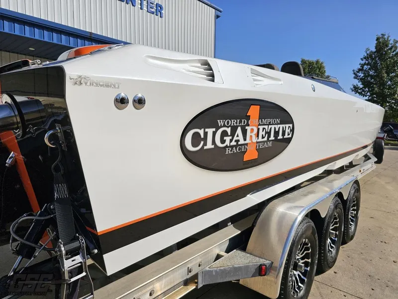 Slide: The Image of 2003 Cigarette 36 Gladiator powerboat on trailer, featuring racing team logo. - 13