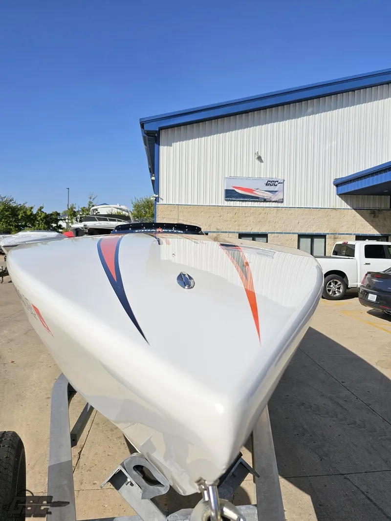 Slide: The Image of 2003 Cigarette 36 Gladiator boat on trailer, parked outside a building under clear blue sky. - 21