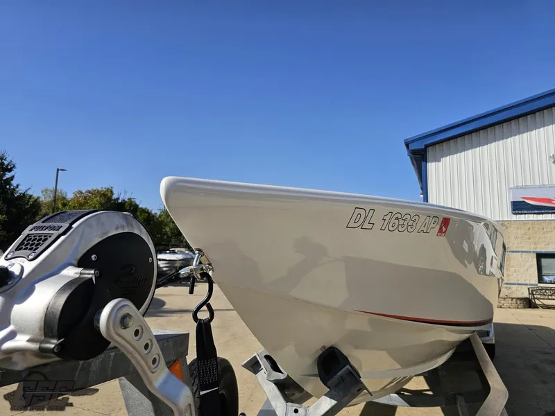Slide: The Image of 2003 Cigarette 36 Gladiator boat on trailer, parked outdoors under clear blue sky. - 22
