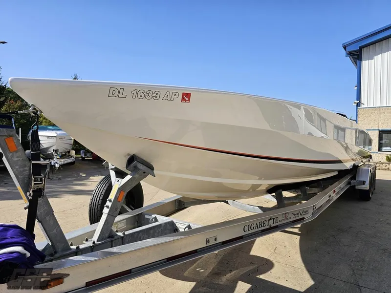 Slide: The Image of 2003 Cigarette 36 Gladiator boat on trailer, parked outdoors. - 23