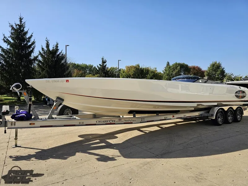 Slide: The Image of 2003 Cigarette 36 Gladiator speedboat on trailer, parked outdoors. - 24