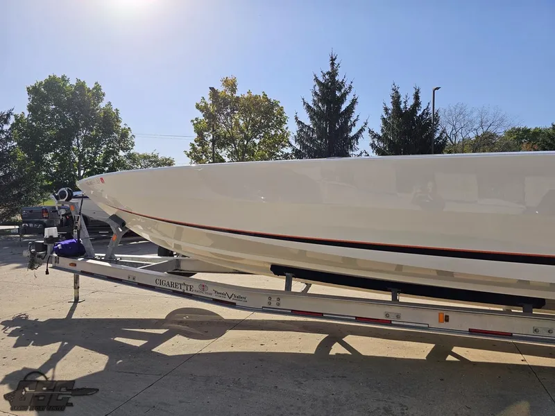 Slide: The Image of 2003 Cigarette 36 Gladiator boat on trailer, parked outdoors under clear sky. - 26