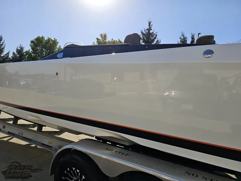 Slide: The Image of 2003 Cigarette 36 Gladiator boat on trailer, side view, under bright sunlight. - 31