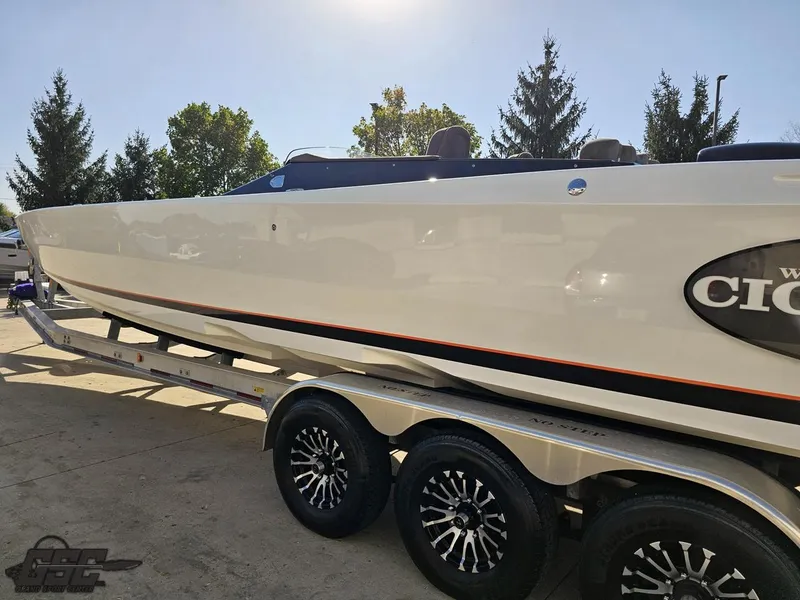 Slide: The Image of 2003 Cigarette 36 Gladiator boat on trailer, sleek design, parked outdoors. - 32