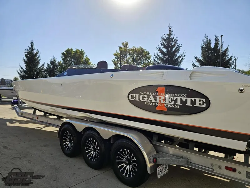 Slide: The Image of 2003 Cigarette 36 Gladiator speedboat on trailer, featuring racing team logo. - 33