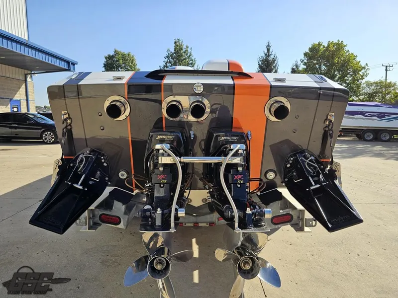 Slide: The Image of 2003 Cigarette 36 Gladiator boat with dual engines and vibrant orange stripe. - 36