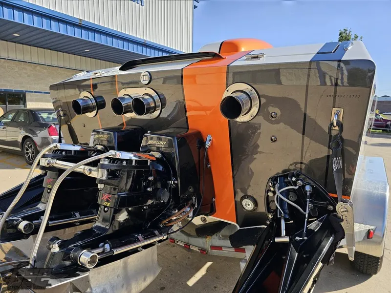 Slide: The Image of 2003 Cigarette 36 Gladiator boat with dual Mercury engines, parked on a trailer. - 37