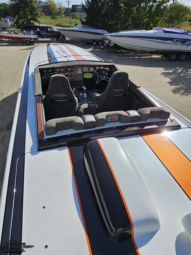 Slide: The Image of 2003 Cigarette 36 Gladiator speedboat with sleek design and vibrant orange stripes. - 42