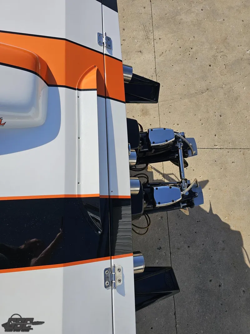 Slide: The Image of 2003 Cigarette 36 Gladiator boat with orange and black stripes, viewed from above. - 44