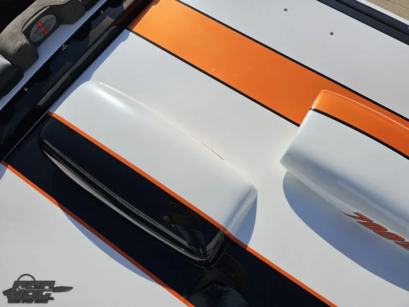 Slide: The Image of 2003 Cigarette 36 Gladiator boat with orange and black stripes on the deck. - 48