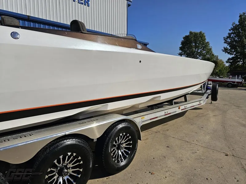 Slide: The Image of 2003 Cigarette 36 Gladiator boat on trailer, parked outdoors. - 9