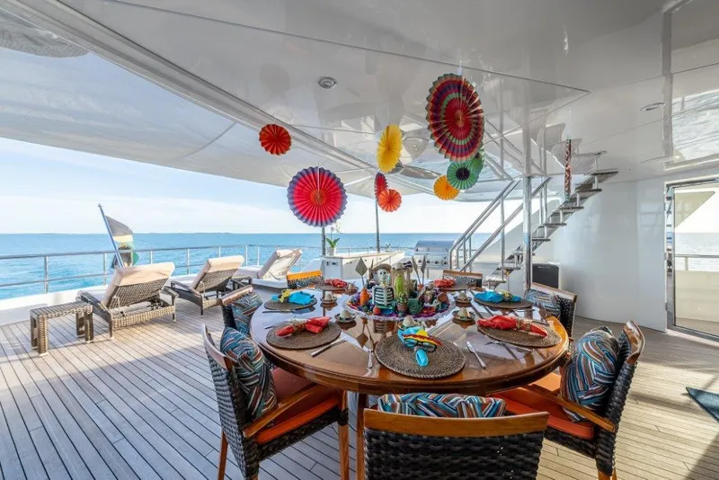Slide: The Image of Luxurious 2013 Westport W164 yacht deck with festive dining setup and ocean view. - 10
