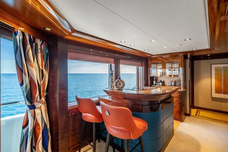 Slide: The Image of Luxurious yacht interior with ocean view, featuring a stylish bar and vibrant decor. - 15