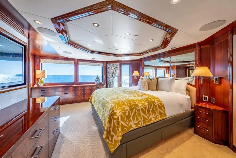 Slide: The Image of Luxurious 2013 Westport W164 yacht bedroom with ocean view, elegant wood finishes, and plush bedding. - 16